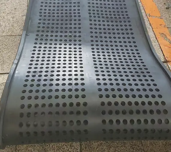 Straight-cleat perforated rubber track for shot blasting machines