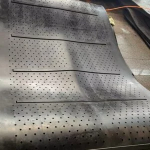 Perforated shot blasting belt for tumble blast machines