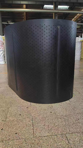 Perforated rubber track with drainage holes and cleat detail