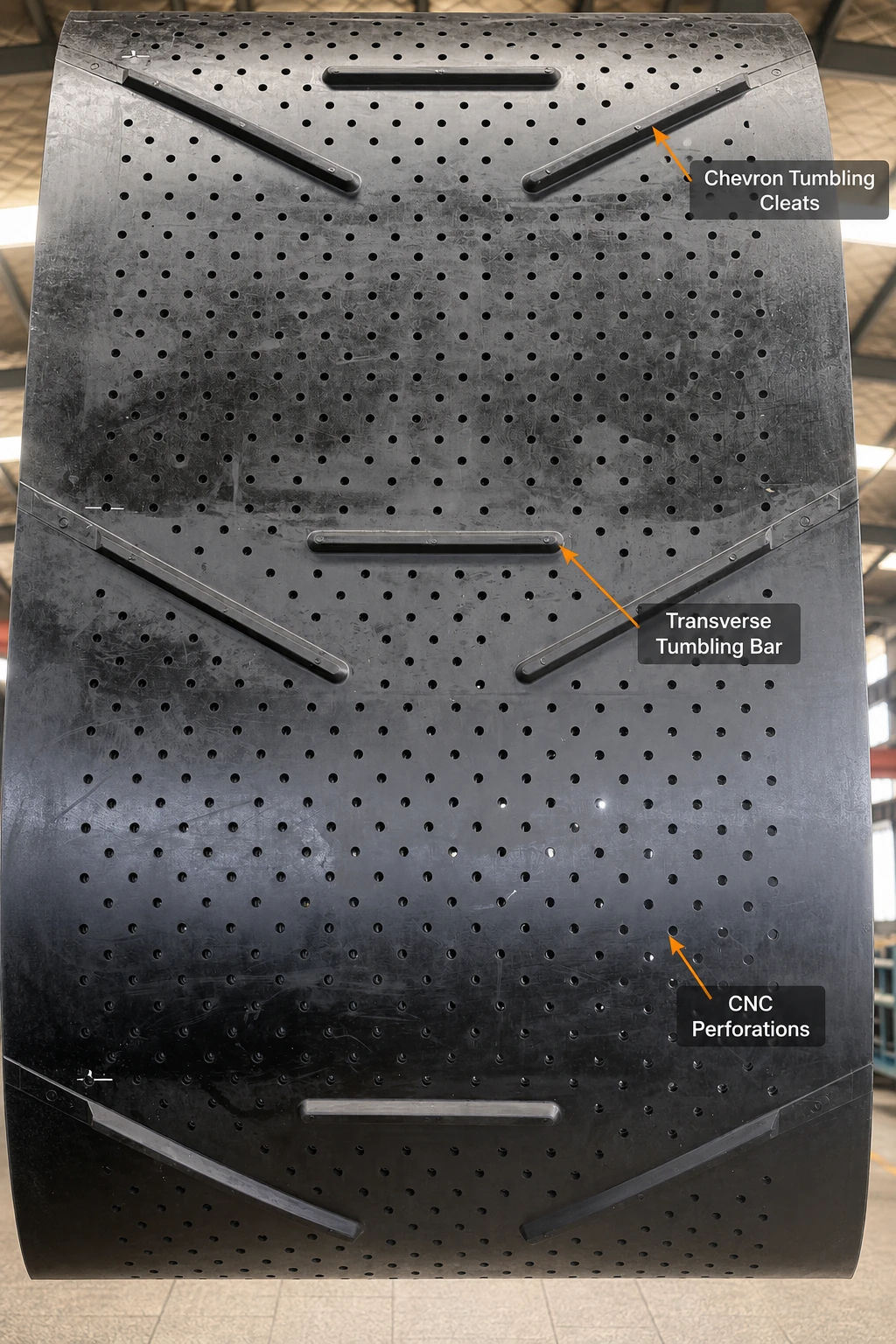 Tumble blast rubber track with chevron tumbling cleats, transverse tumbling bar and CNC perforations